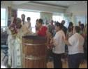 27 Priest leads baptised and sponsors around the font small